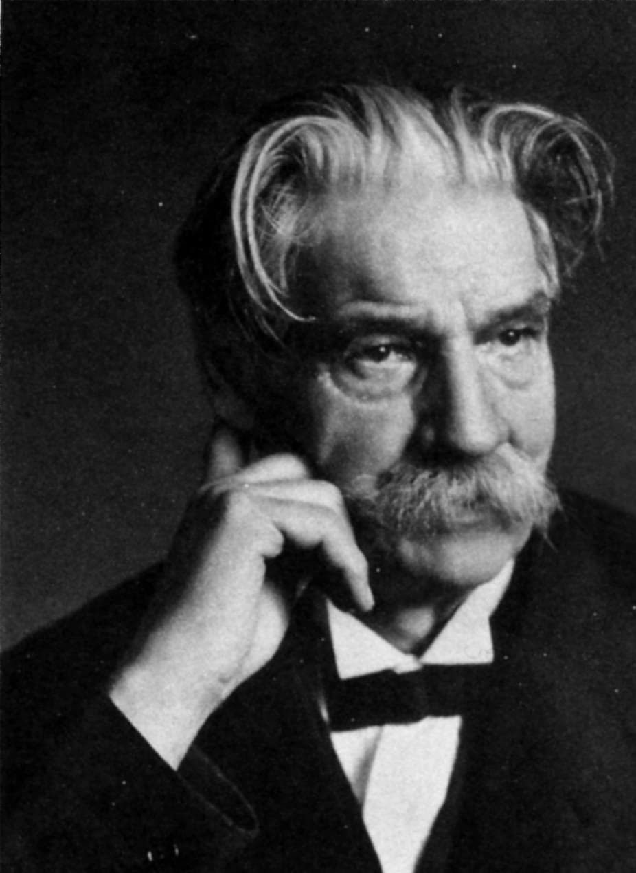 Black and white portrait of Albert Schweitzer with white hair and moustache, hand on cheek